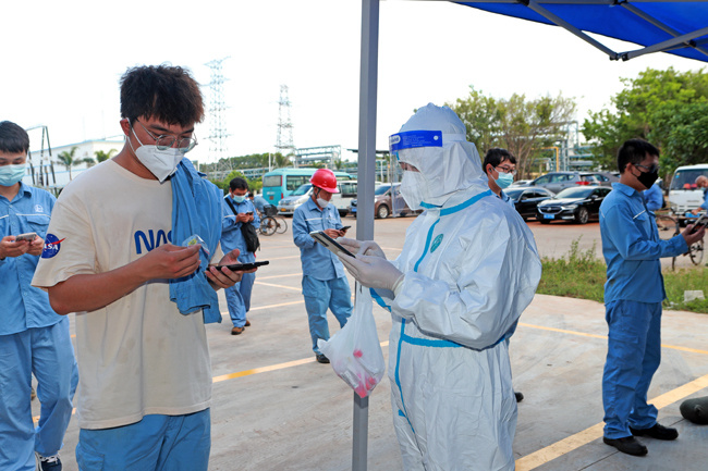 黨員志願者正在配合廠區內核酸檢測掃碼。