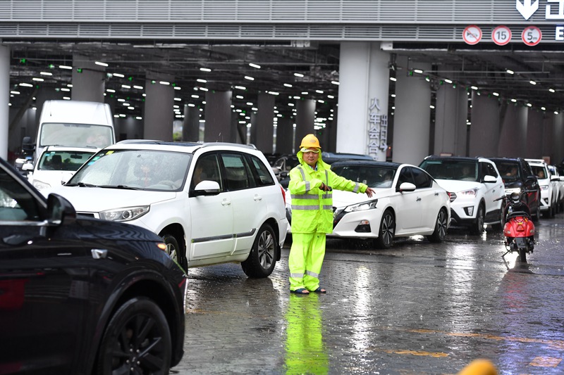 海口新海港工作人员雨中引导车辆。孙士杰摄