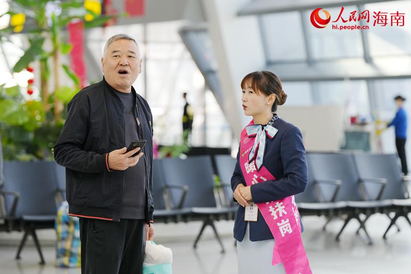 工作人员在现场向乘客答疑解惑。人民网记者 符武平摄